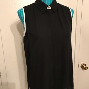 Black sleeveless blouse with much detail.